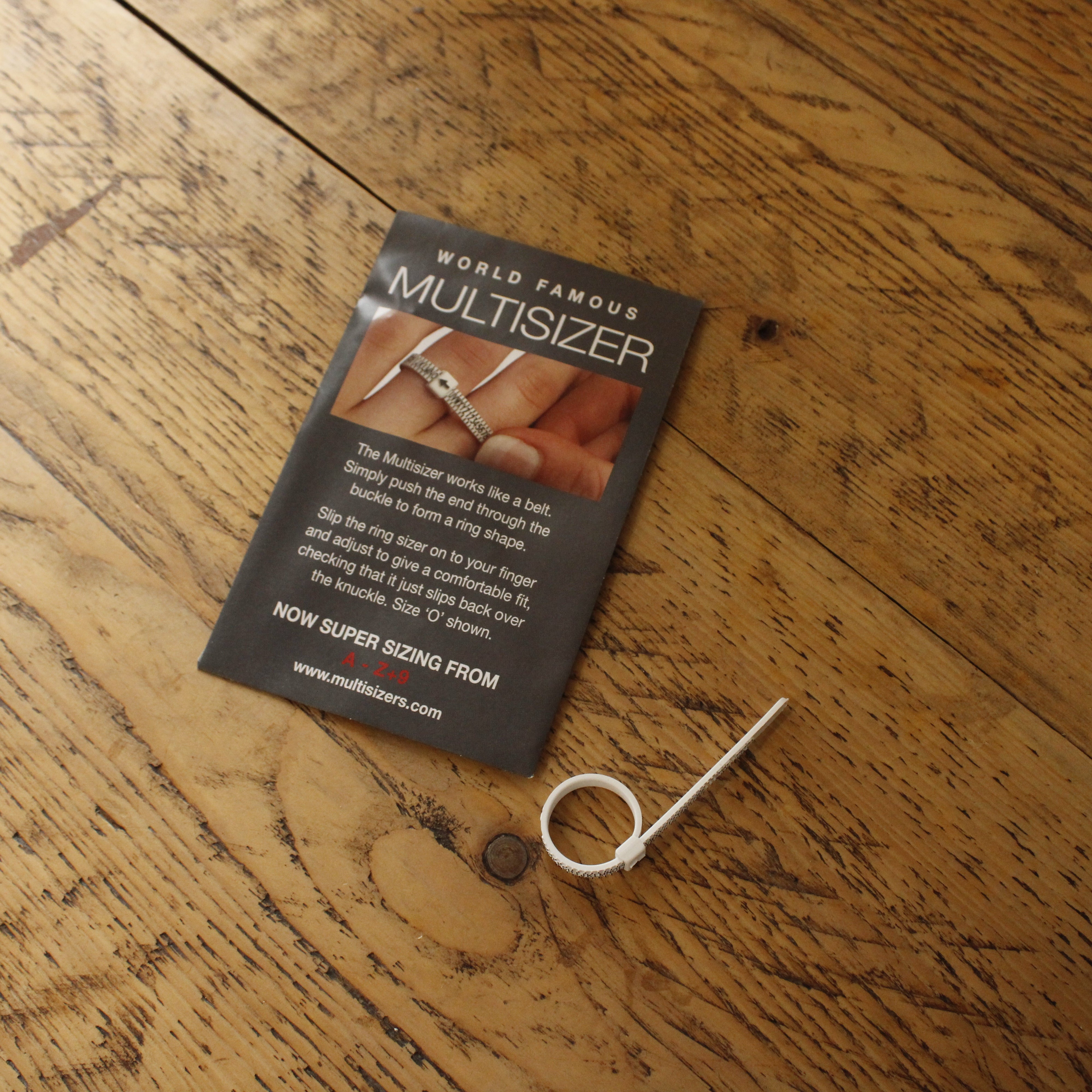 Multisizer card and tool on a wooden surface