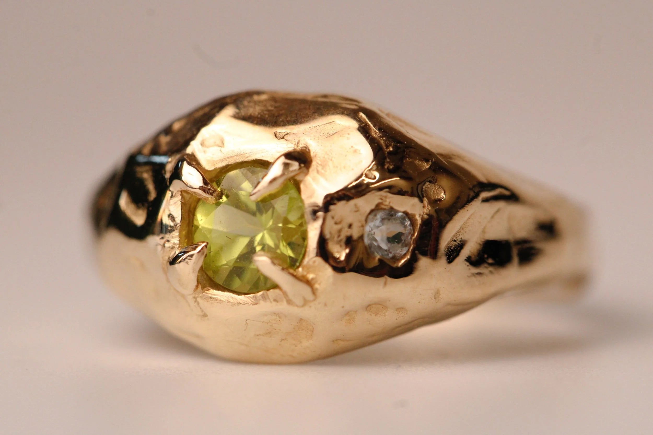 Gold ring with a green gemstone